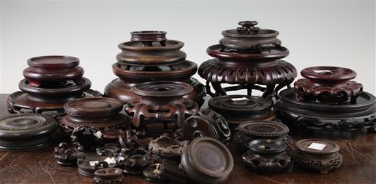 A collection of approximately thirty Chinese and Oriental hardwood stands, largest 18 x 10cm, smallest 3 x 2cm